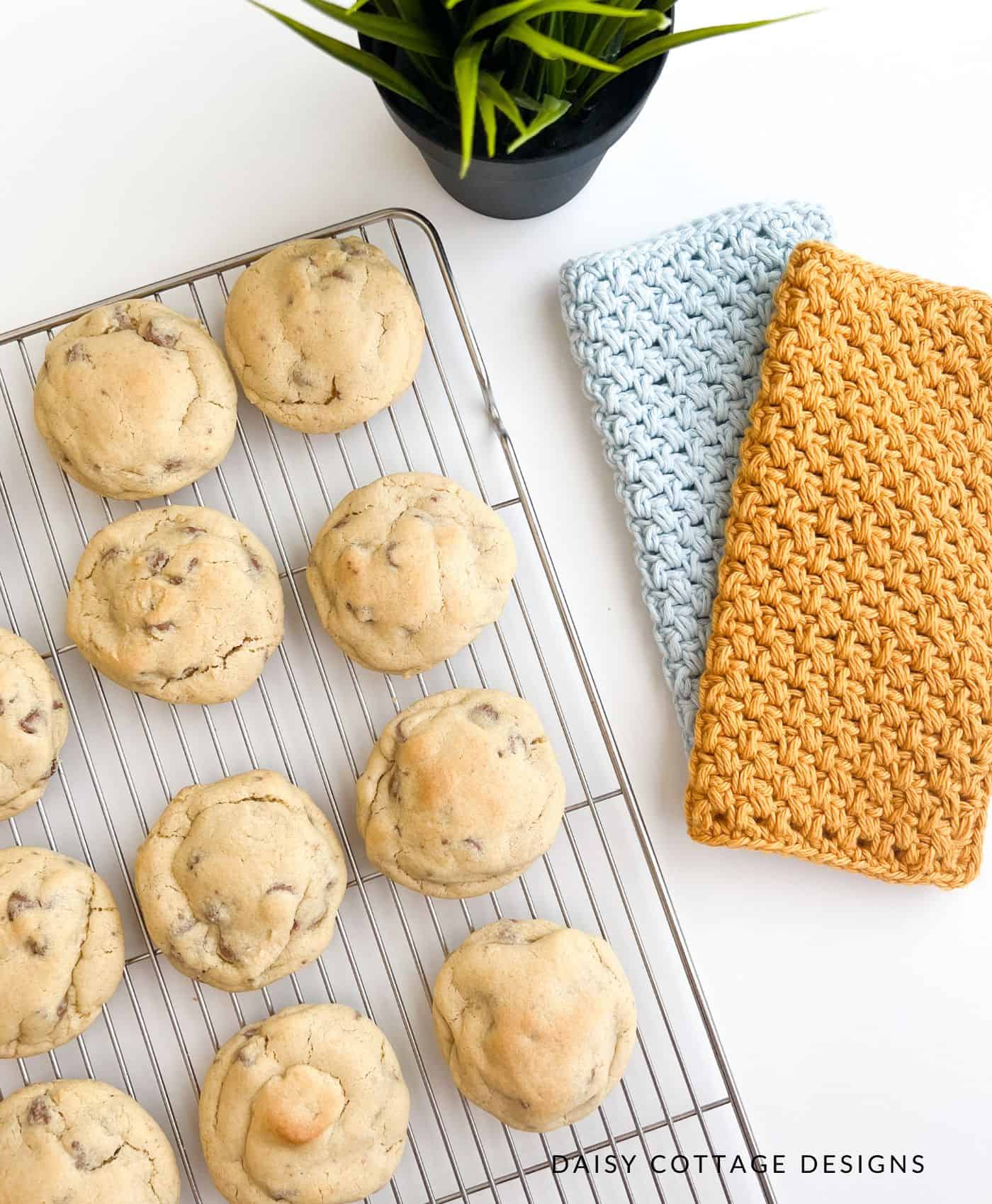 Chocolate chip cookies on a cooling rack with crochet dishcloths