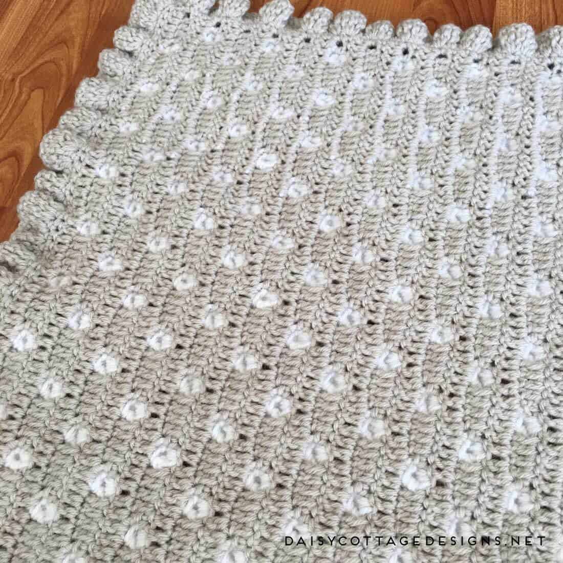 free crochet pattern | crochet blanket pattern | crochet baby blanket | polkadot blanket | Daisy Cottage Designs | Use this free crochet baby blanket pattern to make an adorable baby shower gift. Or, make a larger size and throw it over your couch, chair, or bed. It's a beautiful pattern with detailed instructions and a video tutorial. 