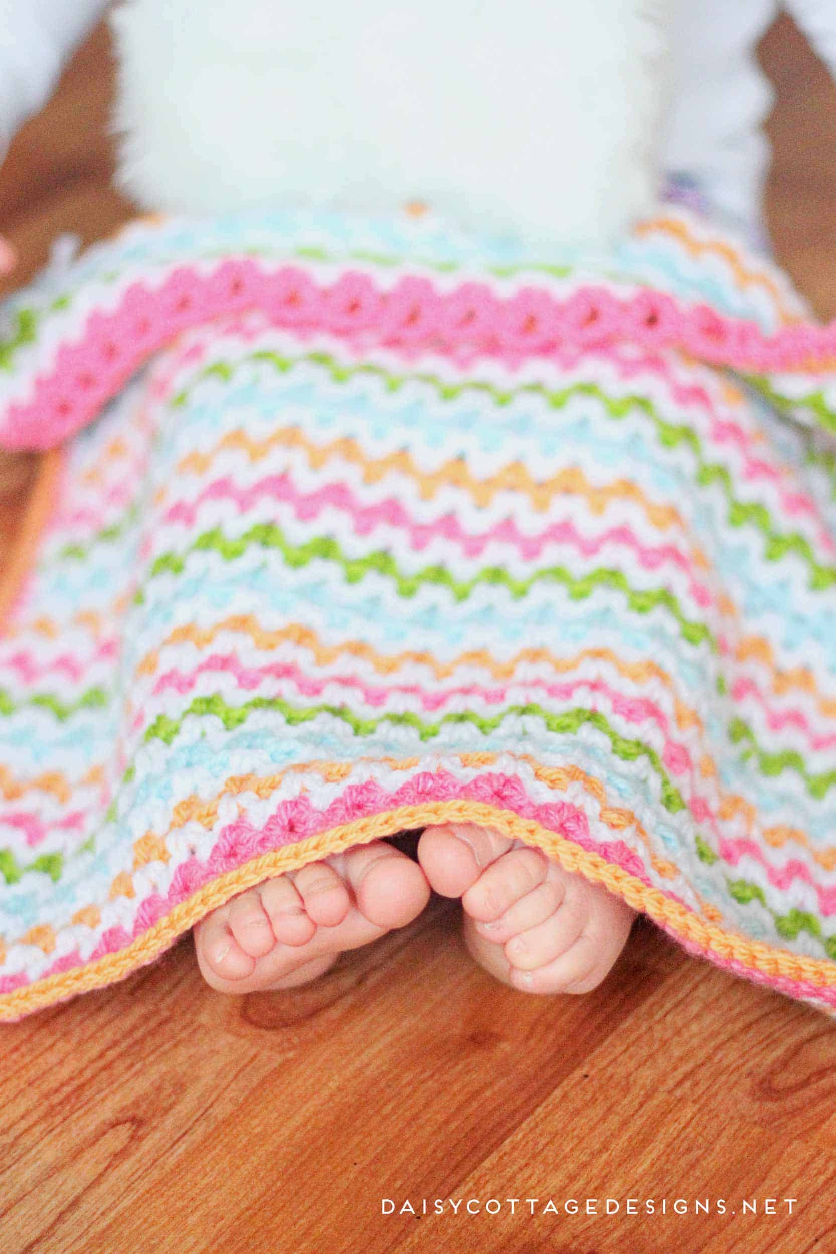 Use this adorable v stitch crochet pattern to create this crochet baby blanket in any size you wish. Free crochet pattern from Daisy Cottage Designs. | baby blanket crochet pattern, easy crochet patter, free crochet pattern, rainbow blanket crochet pattern 