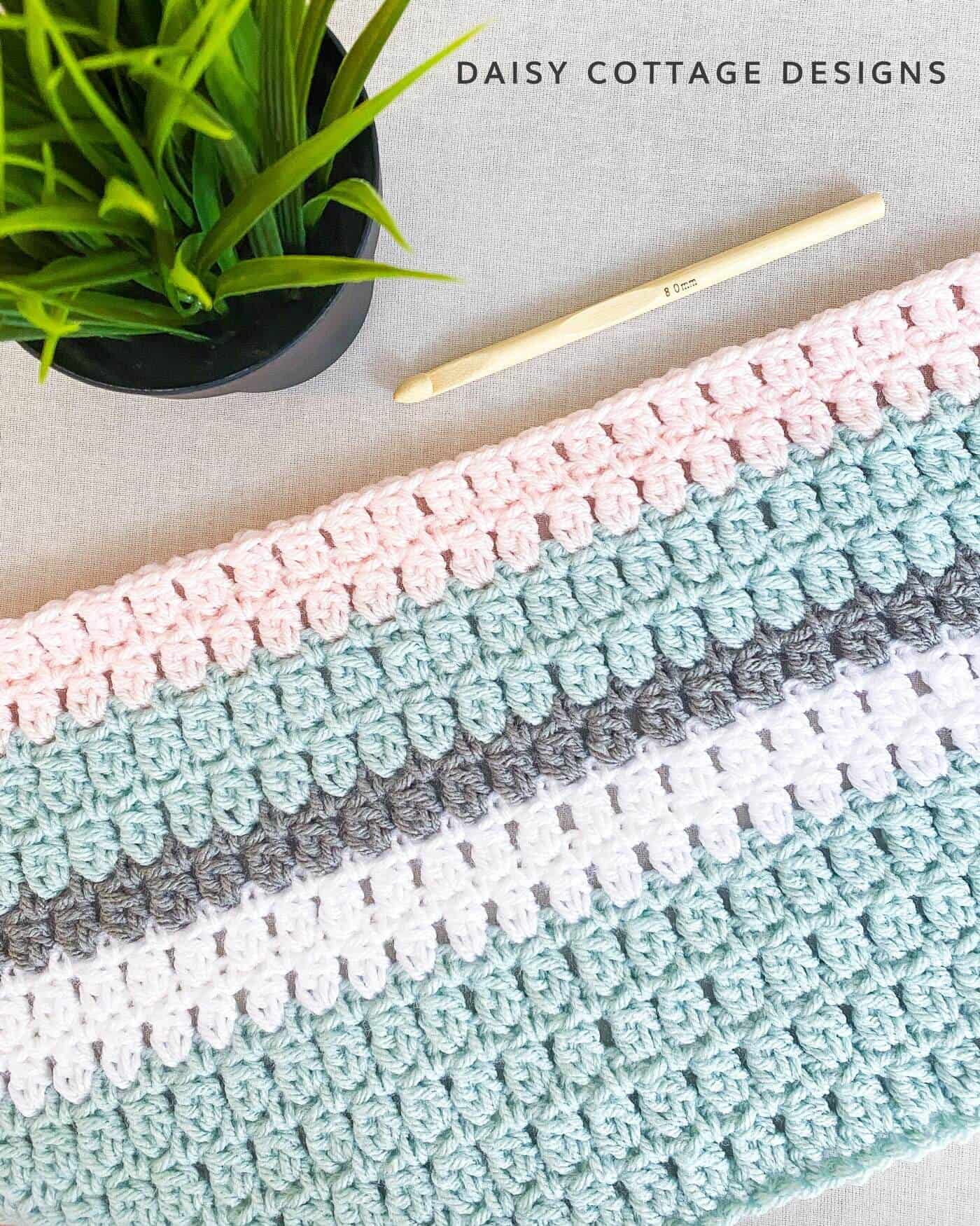 Learn how to make a double crochet cluster stitch using this crochet tutorial from Daisy Cottage Designs.