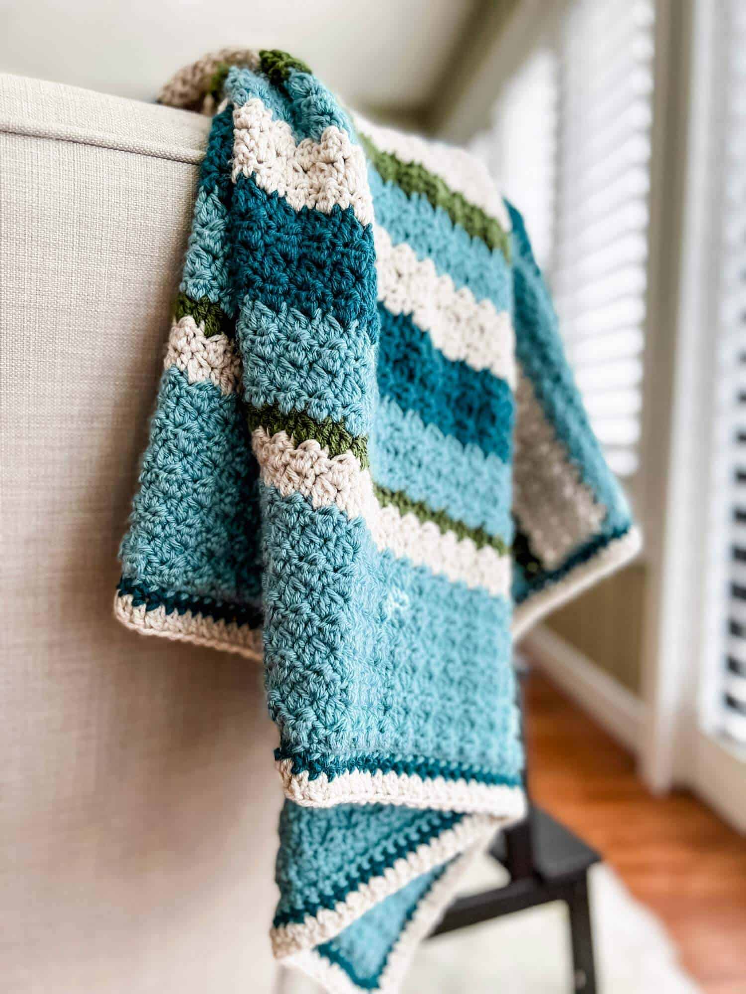 striped crochet blanket on a chair