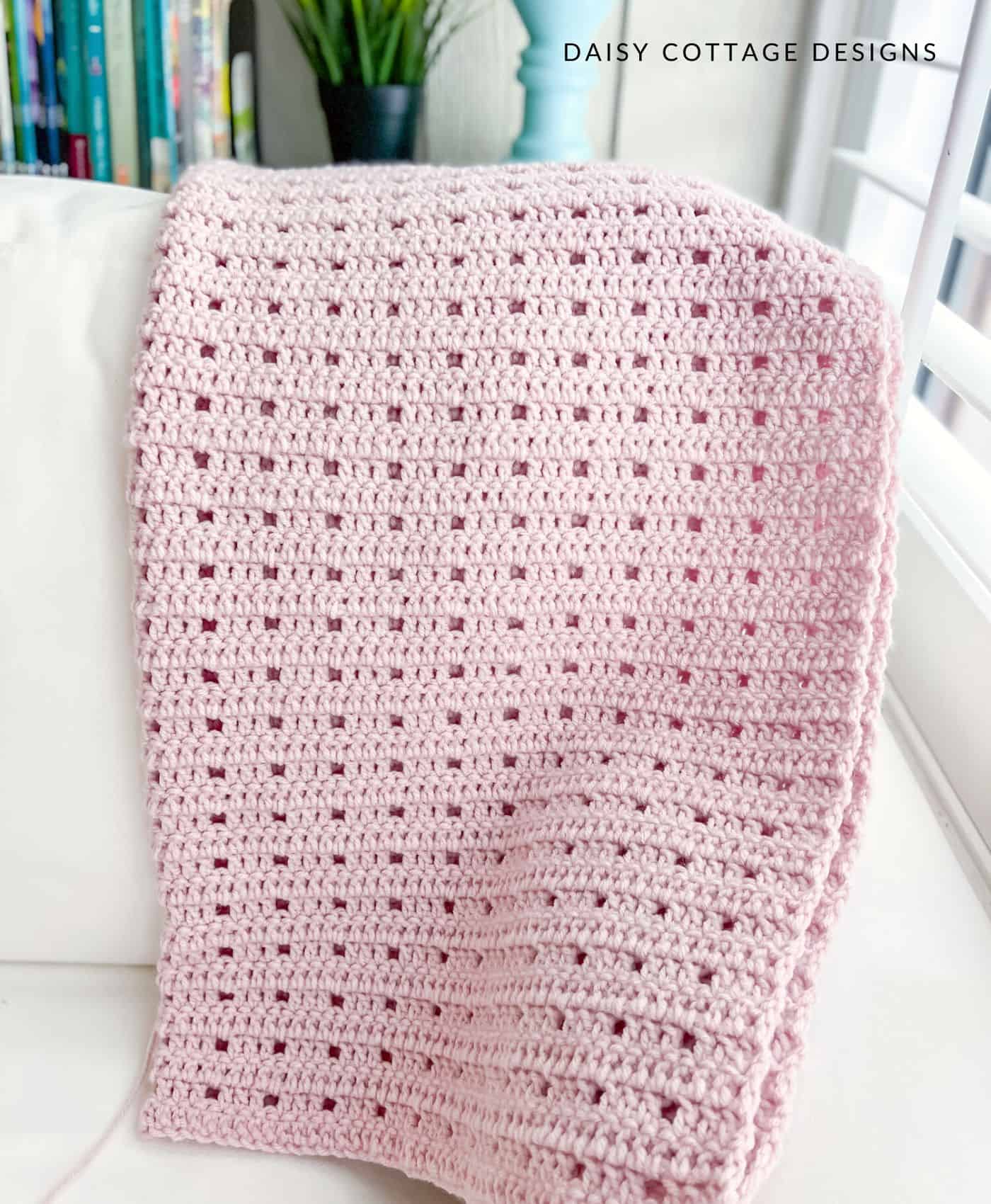 Simple crochet blanket on white couch