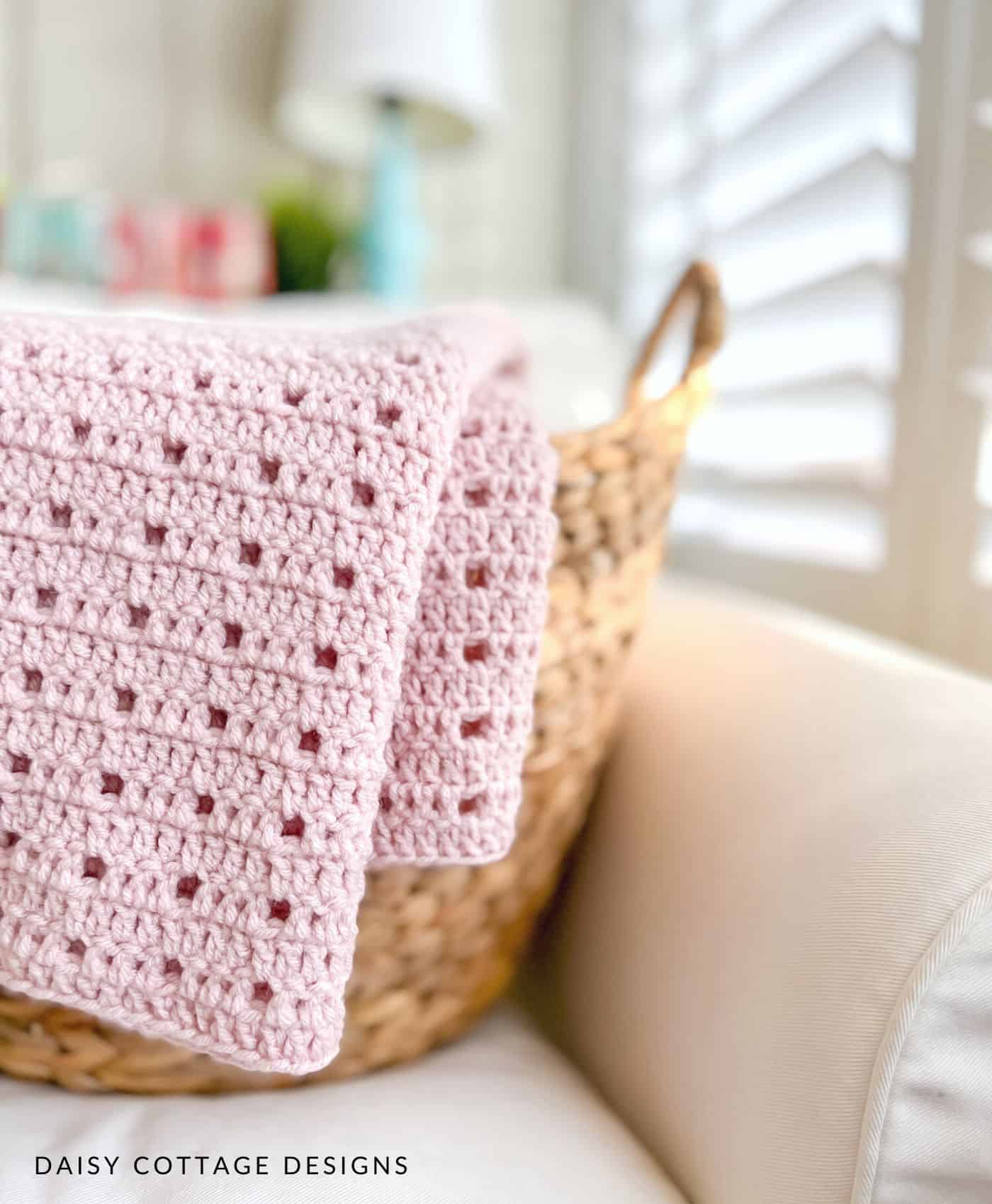 Pink crochet blanket over basket