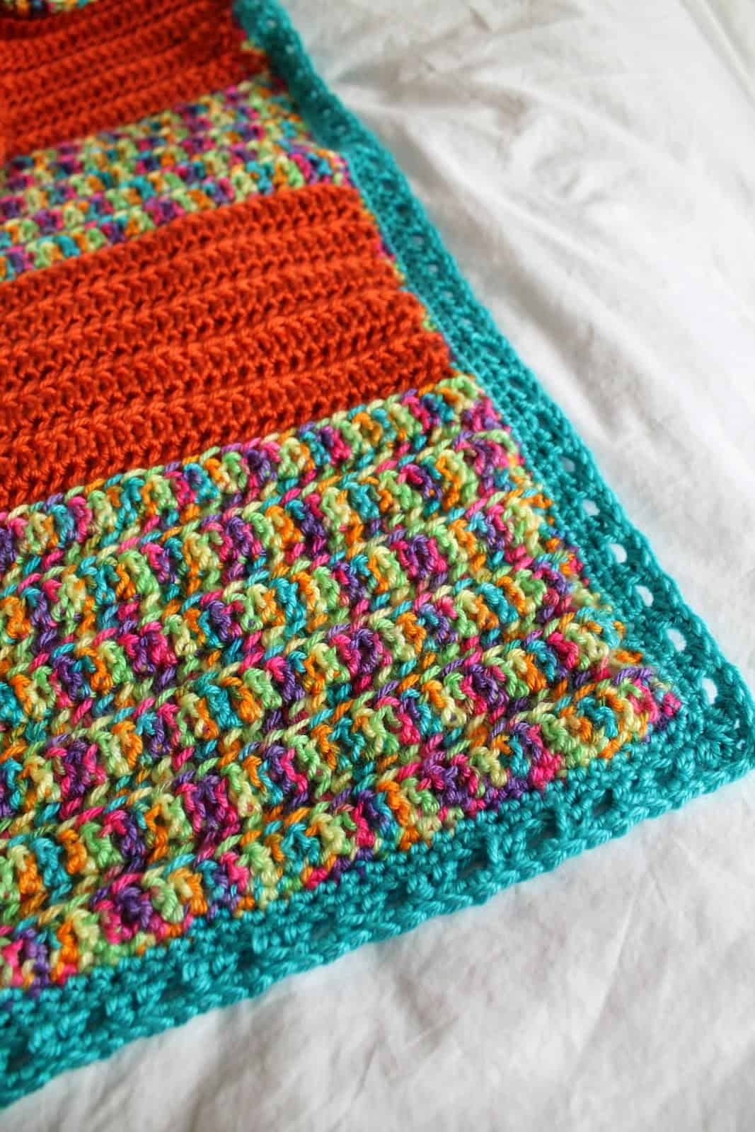 Crochet baby blanket on white background