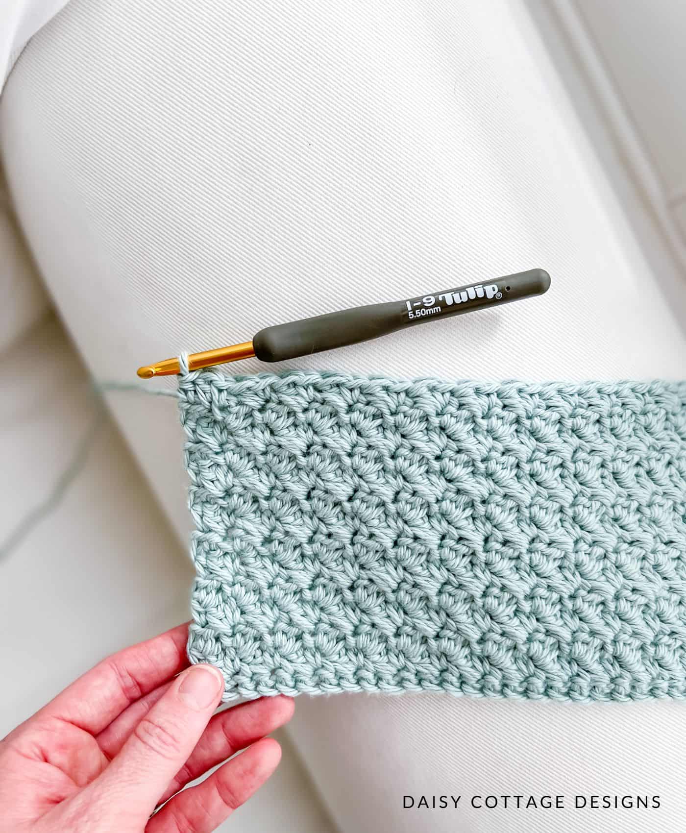 Suzette Stitch Crochet Swatch on the arm of a white couch