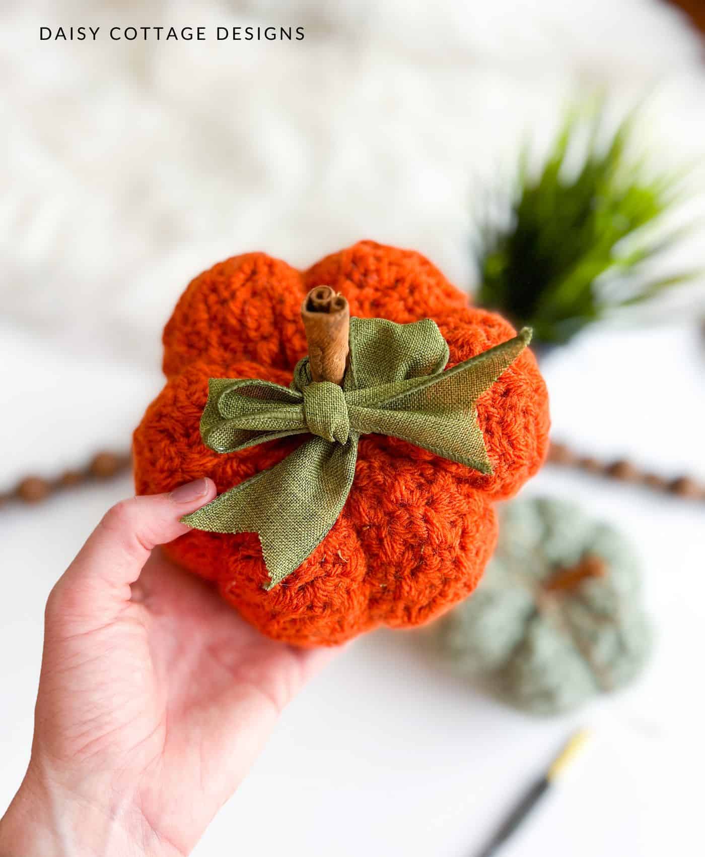 orange crocheted pumpkin with green linen bow