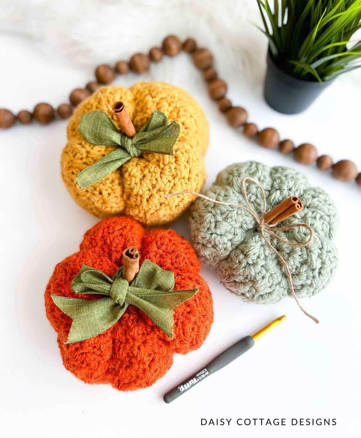 Crocheted pumpkins on white background